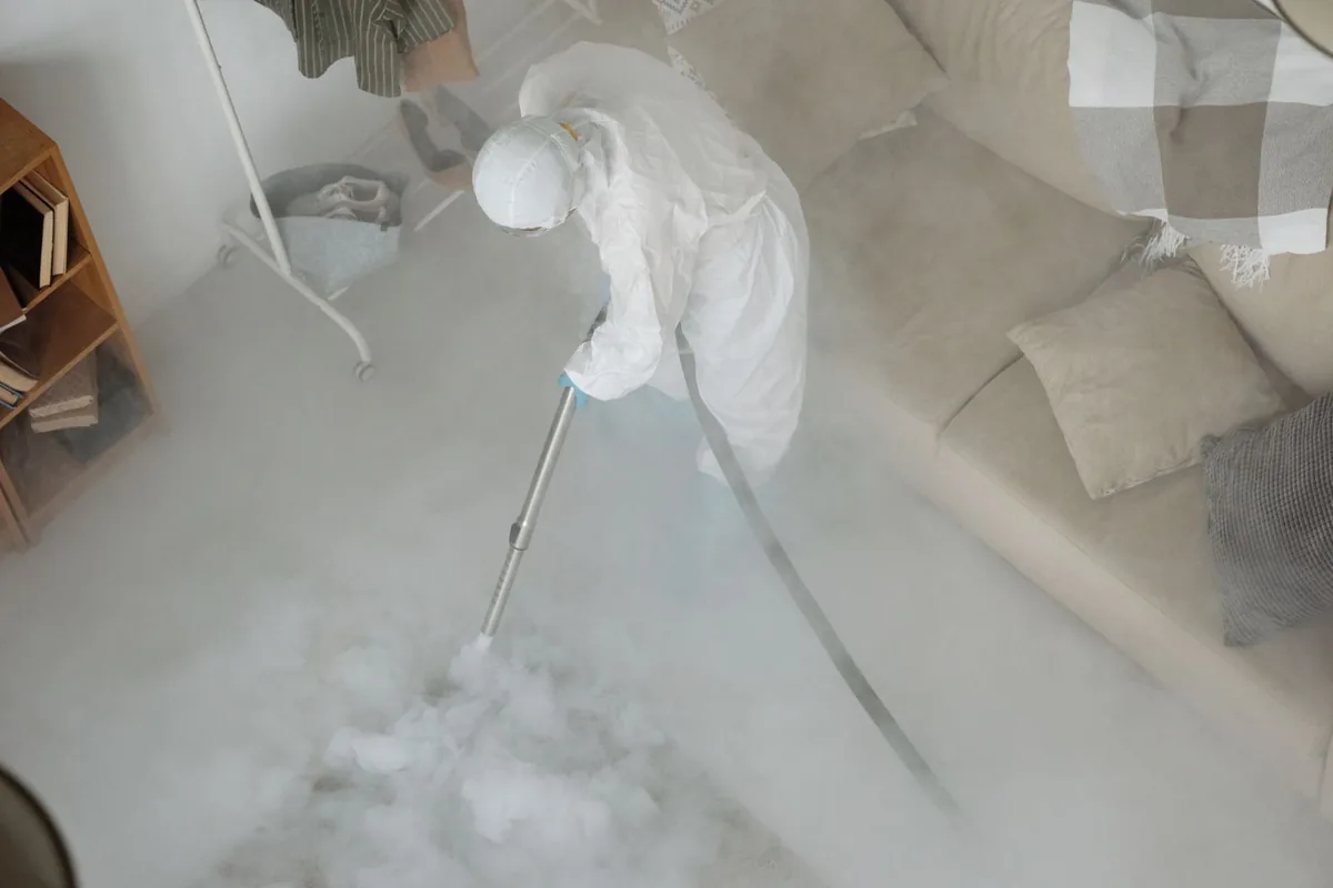 Biohazard cleanup technician in protective equipment, Monona, IA